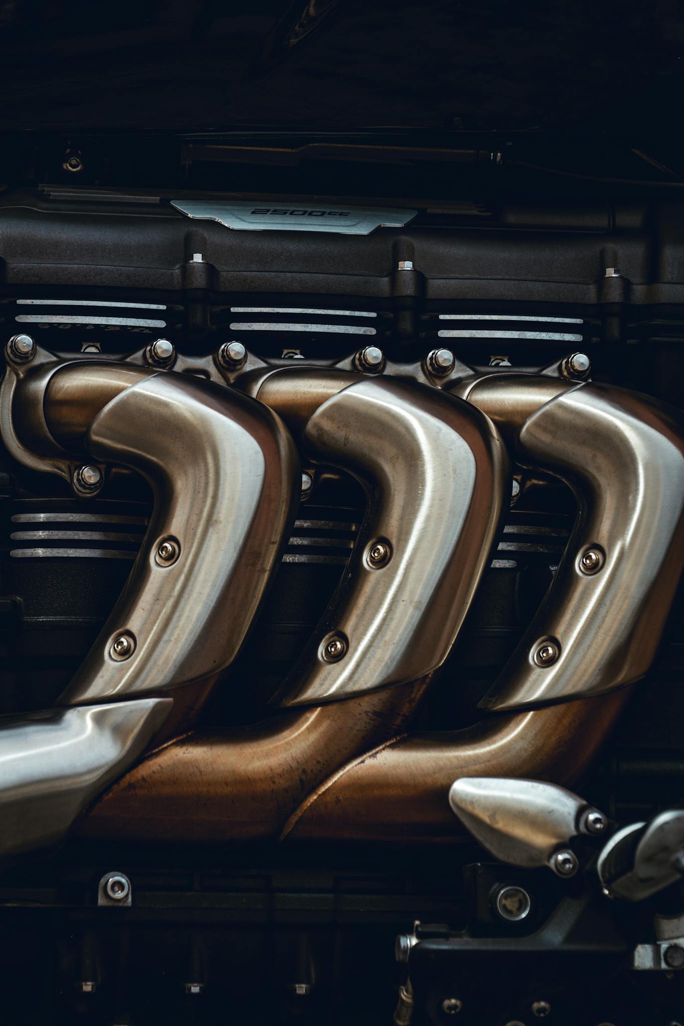 Detailed look at polished metal engine exhaust pipes showing craftsmanship in technology.
